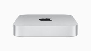 M2 Mac Mini front with apple logo on top near middle rear of image- no features on front